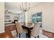 Elegant dining area with hardwood floors, modern chandelier, and access to the outdoor patio at 181 Atwater Landing Dr, Mooresville, NC 28117