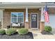 Charming front porch with stone accents, decorative wreath and a bench, offering a warm, inviting welcome at 181 Atwater Landing Dr, Mooresville, NC 28117