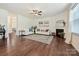 Open-concept living area with hardwood floors, fireplace, two sofas and bright natural light at 181 Atwater Landing Dr, Mooresville, NC 28117