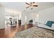 Open-concept living room flowing into dining and kitchen with hardwood floors and modern finishes at 181 Atwater Landing Dr, Mooresville, NC 28117