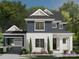 Charming two-story home featuring white brick, navy siding, and a welcoming covered porch at 19104 Newburg Hill Rd, Davidson, NC 28036