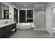 Modern bathroom with dual vanities, soaking tub, and a frameless glass shower at 19110 Newburg Hill Rd, Davidson, NC 28036