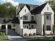 Architectural rendering of a two-story home with white brick, black window frames, and attached garage at 19110 Newburg Hill Rd, Davidson, NC 28036