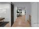 Bright hallway featuring hardwood floors, a barn door, and an open view into the living room at 19110 Newburg Hill Rd, Davidson, NC 28036