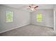 Spacious bedroom with vaulted ceiling, carpet and lots of natural light from two sunny windows at 200 Lake George Dr, Shelby, NC 28152
