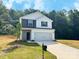 Charming two-story home featuring a mix of siding and stone accents, plus a two-car garage at 200 Lake George Dr, Shelby, NC 28152