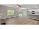 Open-concept living room with light wood flooring, natural light, and a modern kitchen at 200 Lake George Dr, Shelby, NC 28152