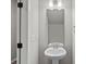 The powder room features a pedestal sink, brushed nickel fixtures, and new paint at 200 Lake George Dr, Shelby, NC 28152
