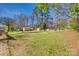 Spacious backyard with a fenced perimeter, utility sheds, and play set at 2027 Franklin St, Rock Hill, SC 29732