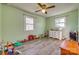 bedroom features ceiling fan, hardwood floors, white dresser, and two windows at 2027 Franklin St, Rock Hill, SC 29732