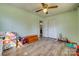 bedroom features ceiling fan, hardwood floors, lots of toys, and white closet at 2027 Franklin St, Rock Hill, SC 29732