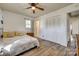 Bedroom featuring wood flooring, ceiling fan, double closet, and sunny window at 2027 Franklin St, Rock Hill, SC 29732