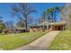 A brick home with a lush green lawn and a long driveway at 2027 Franklin St, Rock Hill, SC 29732