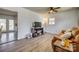 Comfortable living area with a flatscreen TV, wooden floors, and a ceiling fan at 2027 Franklin St, Rock Hill, SC 29732