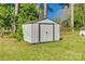 Utility shed in a backyard. The shed is metal with a white door at 2027 Franklin St, Rock Hill, SC 29732
