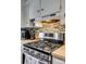 Close-up of a gas stove with stainless steel appliances and tile backsplash at 2027 Franklin St, Rock Hill, SC 29732