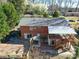 Aerial view of brick home featuring a deck, patio, and landscaped yard with mature trees at 2036 Edgewater Dr, Charlotte, NC 28210