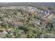 Wide aerial view of a wooded neighborhood with houses, surrounded by trees, showcasing the community's layout at 2036 Edgewater Dr, Charlotte, NC 28210