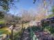 Expansive backyard with a pond, greenhouse, and mature trees, offering a private retreat at 2036 Edgewater Dr, Charlotte, NC 28210
