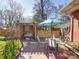 Outdoor living space with swing, table, chairs, brick patio, and privacy fence at 2036 Edgewater Dr, Charlotte, NC 28210