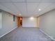 Spacious carpeted basement with neutral walls, recessed lighting, and doors to other rooms, maximizing usable space at 2036 Edgewater Dr, Charlotte, NC 28210