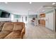 Open basement with kitchen, seating, and access to the backyard through double doors at 2036 Edgewater Dr, Charlotte, NC 28210