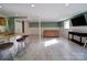 Finished basement with bar seating, tile flooring, wainscoting, and modern fixtures offers inviting living space at 2036 Edgewater Dr, Charlotte, NC 28210