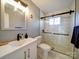 Bathroom showcasing walk-in shower, sleek fixtures, marble-style wall and floor tiling at 2036 Edgewater Dr, Charlotte, NC 28210