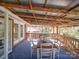 Inviting outdoor deck with a metal roof, table, and seating, creating an ideal spot for relaxation at 2036 Edgewater Dr, Charlotte, NC 28210
