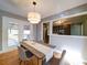 Elegant dining room with modern lighting and views of the kitchen and outdoor deck at 2036 Edgewater Dr, Charlotte, NC 28210