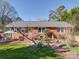 Charming brick home with a beautiful landscaped yard, stone water feature, and outdoor seating area at 2036 Edgewater Dr, Charlotte, NC 28210