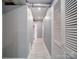 Neutral-toned hallway featuring white paneled doors and tiled floors leads to additional living spaces at 2036 Edgewater Dr, Charlotte, NC 28210