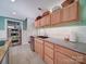 Basement kitchen with stainless steel appliances, granite counters, white subway tile backsplash, and wood cabinets at 2036 Edgewater Dr, Charlotte, NC 28210