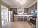 Spacious kitchen with stainless steel appliances and gray cabinets at 2036 Edgewater Dr, Charlotte, NC 28210