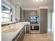 Functional kitchen with stainless steel oven and neutral countertops and backsplash at 2036 Edgewater Dr, Charlotte, NC 28210