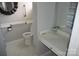 This bathroom features tiled floors, a toilet with safety handles, and a countertop with a large mirror at 2207 Windsor Woods Dr, Gastonia, NC 28054