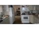 Traditional kitchen features white appliances, wood floors, and ample cabinet space at 2207 Windsor Woods Dr, Gastonia, NC 28054