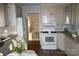Traditional kitchen features white appliances, wood floors, and ample cabinet space at 2207 Windsor Woods Dr, Gastonia, NC 28054