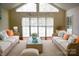 Bright sunroom with vaulted ceilings, wicker furniture, and large windows for natural light at 2207 Windsor Woods Dr, Gastonia, NC 28054