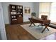 Home office with hardwood floors, custom shelving, and a large desk with great natural light at 2207 Windsor Woods Dr, Gastonia, NC 28054