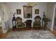 Elegant sitting room featuring a chandelier, mirror, chairs, and hardwood flooring at 2207 Windsor Woods Dr, Gastonia, NC 28054