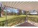 Back porch with iron railings that overlooks the expansive backyard and surrounding greenery at 2509 Wesley Chapel Rd, Indian Trail, NC 28079