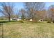 Large, grassy backyard with mature trees and additional storage at 2509 Wesley Chapel Rd, Indian Trail, NC 28079
