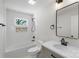 Bright bathroom featuring a shower and tub combination with a decorative stone alcove at 2509 Wesley Chapel Rd, Indian Trail, NC 28079