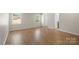 Bright bedroom featuring hardwood floors and two large windows at 2509 Wesley Chapel Rd, Indian Trail, NC 28079