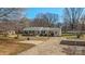 Ranch home with mature landscaping, driveway and parking area at 2509 Wesley Chapel Rd, Indian Trail, NC 28079