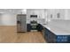Modern kitchen featuring stainless steel appliances, white cabinets, and stone countertops at 2509 Wesley Chapel Rd, Indian Trail, NC 28079