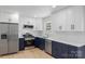 Modern kitchen featuring stainless steel appliances, white cabinets, and stone countertops at 2509 Wesley Chapel Rd, Indian Trail, NC 28079
