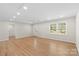 Bright and open living area with hardwood floors, recessed lighting, and a large window at 2509 Wesley Chapel Rd, Indian Trail, NC 28079