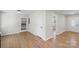 Living room featuring hardwood floors, white trim, and a doorway at 2509 Wesley Chapel Rd, Indian Trail, NC 28079